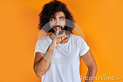 Calm curly arabic man keep silence, have secret Stock Photo