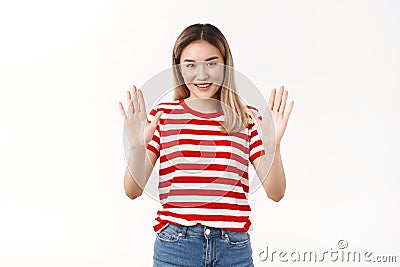 Calm down got situation under control. Assertive optimistic asian blond girl assuring everything okay asking relax take Stock Photo