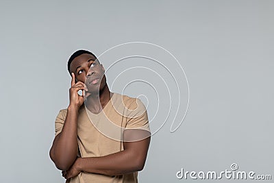 Calm dreaming man looking up and to side Stock Photo