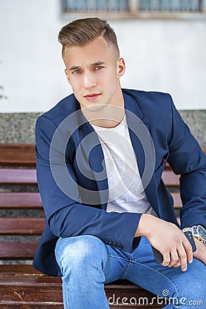 Calm handsome man on the background of summer street Stock Photo