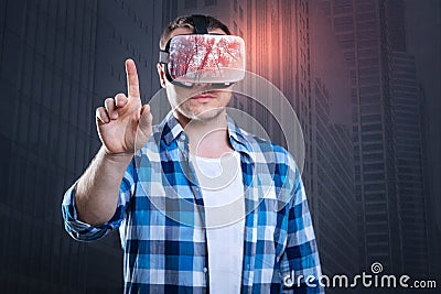 Calm handsome man opening virtual reality Stock Photo