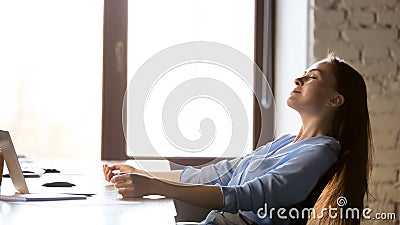 Calm businesswoman relaxing in comfortable office chair at work Stock Photo