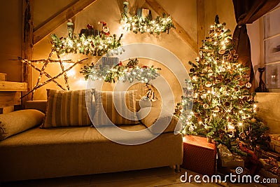 Calm image of interior modern home living room decorated christmas tree and gifts, sofa, table covered with blanket. Stock Photo