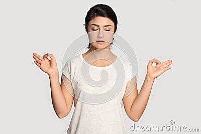 Calm Indian woman practice yoga relieving negativity Stock Photo