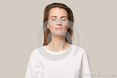 Calm mindful woman with closed eyes breathing deep, no stress Stock Photo