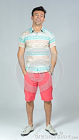 Calm and relaxed man with hands in his pocket. Handsome brazilian male wears colorful summer shirt. 30s.. Stock Photo