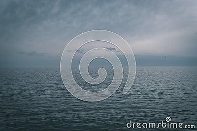 Calm sea with cloudy sky at the horizon - perfect for relaxation Stock Photo