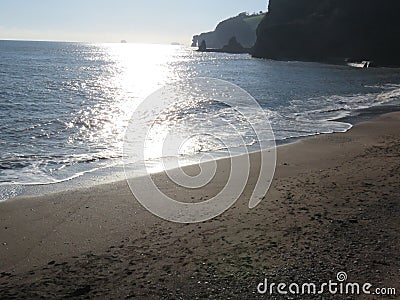 Calm sea waves against a sunny winter sky Coryton Cove Beach, Dawlish Devon Stock Photo