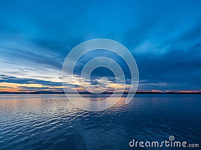Calm, serenity, meditation concept. Sunset on the lake, quiet water, cloudless sky Stock Photo