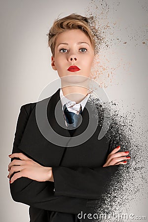 Calm and serious blond business woman in black suit with dispersion effect Stock Photo