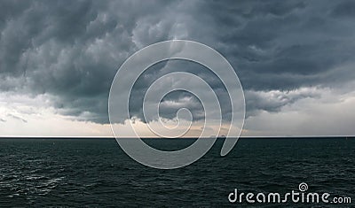 The calm before the storm. Dark dense clouds over the wavy sea Stock Photo