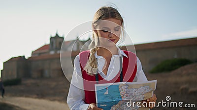 Calm tourist holding map outdoor closeup. Young girl walking searching direction Stock Photo