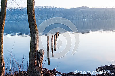 Calm or tranquility of water on wide river in the early morning. Calm surface of river with high opposite bank in blue haze, flood Stock Photo