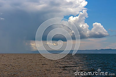 Calm tropical sea under darkening storm clouds Stock Photo