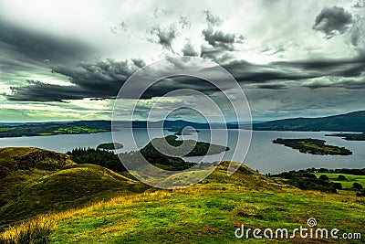 Calm Water And Green Meadows At Loch Lomond In Scotland Stock Photo