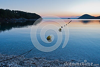 Calm water at Panormos beach after sunset, Skopelos island Stock Photo