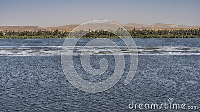 A calm wide blue river. Ripples on the surface. Stock Photo