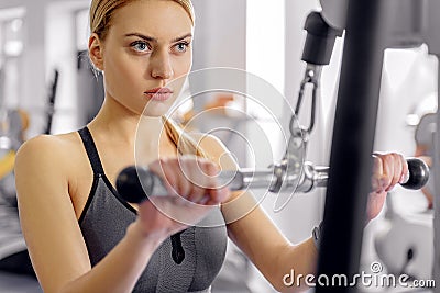 Calm woman working out on equipment Stock Photo