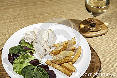 Calorie controlled diet chicken meal with salad and wine Stock Photo