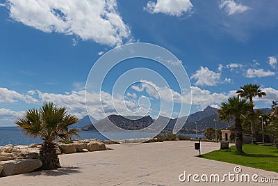 Calpe Spain paseo at foot of Penon de Ifach landmark rock with view of mountains Stock Photo