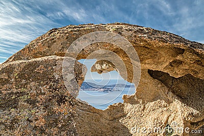 Calvi in Corsica viewed through hole in rock Stock Photo