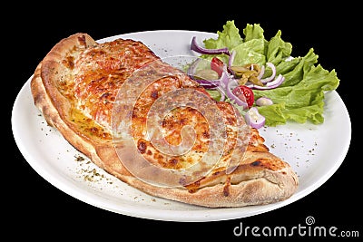 Calzone pizza with tomato sauce, bacon, ham, stewed mushrooms and yellow cheese on a plate Stock Photo