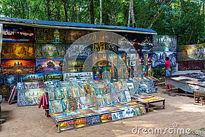 Cambodia. Angkor. Banteay Kdei Temple. Merchant of souvenirs painting at the entrance of temple Editorial Stock Photo