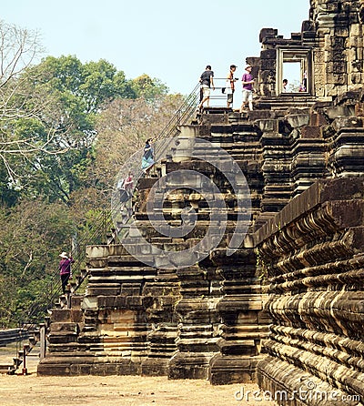 Visitors climbing to mountain temple Baphuon. Angkor, Cambodia Editorial Stock Photo