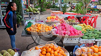 Young Asian girl sells fruit on a city street Editorial Stock Photo