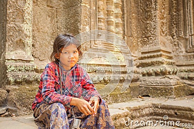 Cambodian child in Ta Prohm ancient temple, Angkor Thom, Siem Reap, Cambodia. Editorial Stock Photo