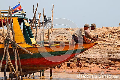 Cambodian floating village boat construction with kids playing Editorial Stock Photo