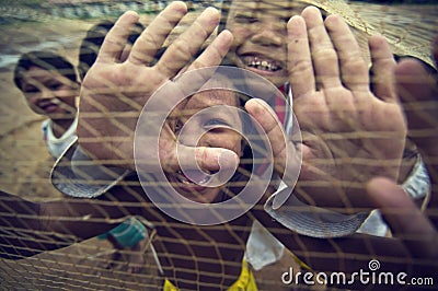 Cambodian kids playing with trawl Stock Photo