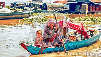 Cambodian people live on Tonle Sap Lake in Siem Reap, Cambodia. Mother with the children in the boat Editorial Stock Photo