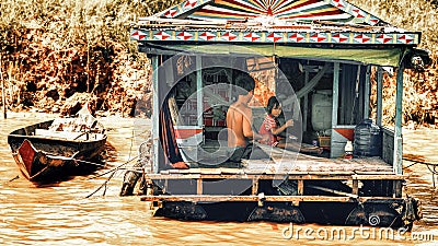 Cambodian people live on Tonle Sap Lake in Siem Reap, Cambodia. Unidentified people in a Floating village on the Tonle Sap Lake Editorial Stock Photo