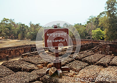 Be Careful Warning sign in Angkor Wat Temple Stock Photo