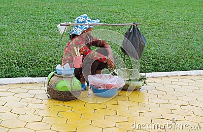 Cambodian woman sell fruits and stuff on the street Editorial Stock Photo