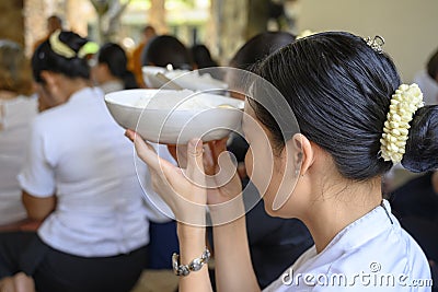 Cambodian women at food offering ceremony praying with bowls of rice. Pchum Ben Day Editorial Stock Photo
