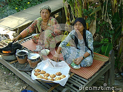 Cambodian women making and selling cakes Editorial Stock Photo