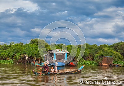 Cambodian women sail on a boat near the fishing village of Tonle Sap Lake Editorial Stock Photo