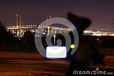 Camcorder filming bridge at night Stock Photo