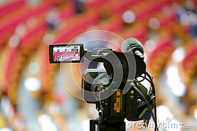 The camcorder stands on a tripod and removes the meeting room. Stock Photo