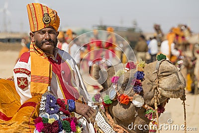 Camel and indian men wearing traditional Rajasthani dress participate in Mr. Desert contest as part of Desert Festival in Jaisalme Editorial Stock Photo