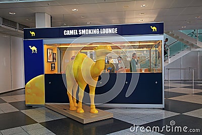 Camel Smoking lounge with passengers inside in Munich International Airport Editorial Stock Photo