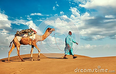 Cameleer camel driver with camels in Rajasthan Stock Photo