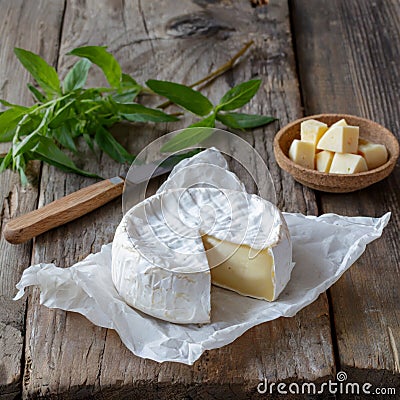 Camembert cheese on rustic wooden table Stock Photo