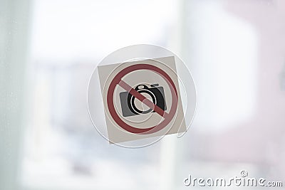 a camera banned symbol icon sticker on the wall in public place, shooting restriction area Stock Photo