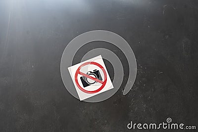 a camera banned symbol icon sticker on the wall in public place, shooting restriction area Stock Photo