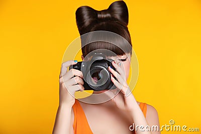 Camera. Beautiful smiling teen girl taking a photo. Pretty model Stock Photo