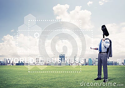 Camera headed man standing on green grass against modern citysca Stock Photo