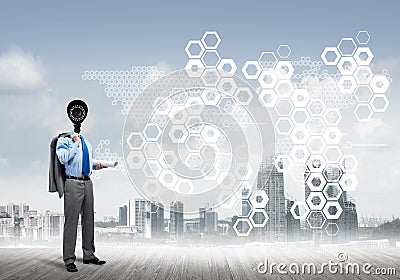 Camera headed man standing on wooden floor against modern cityscape Stock Photo